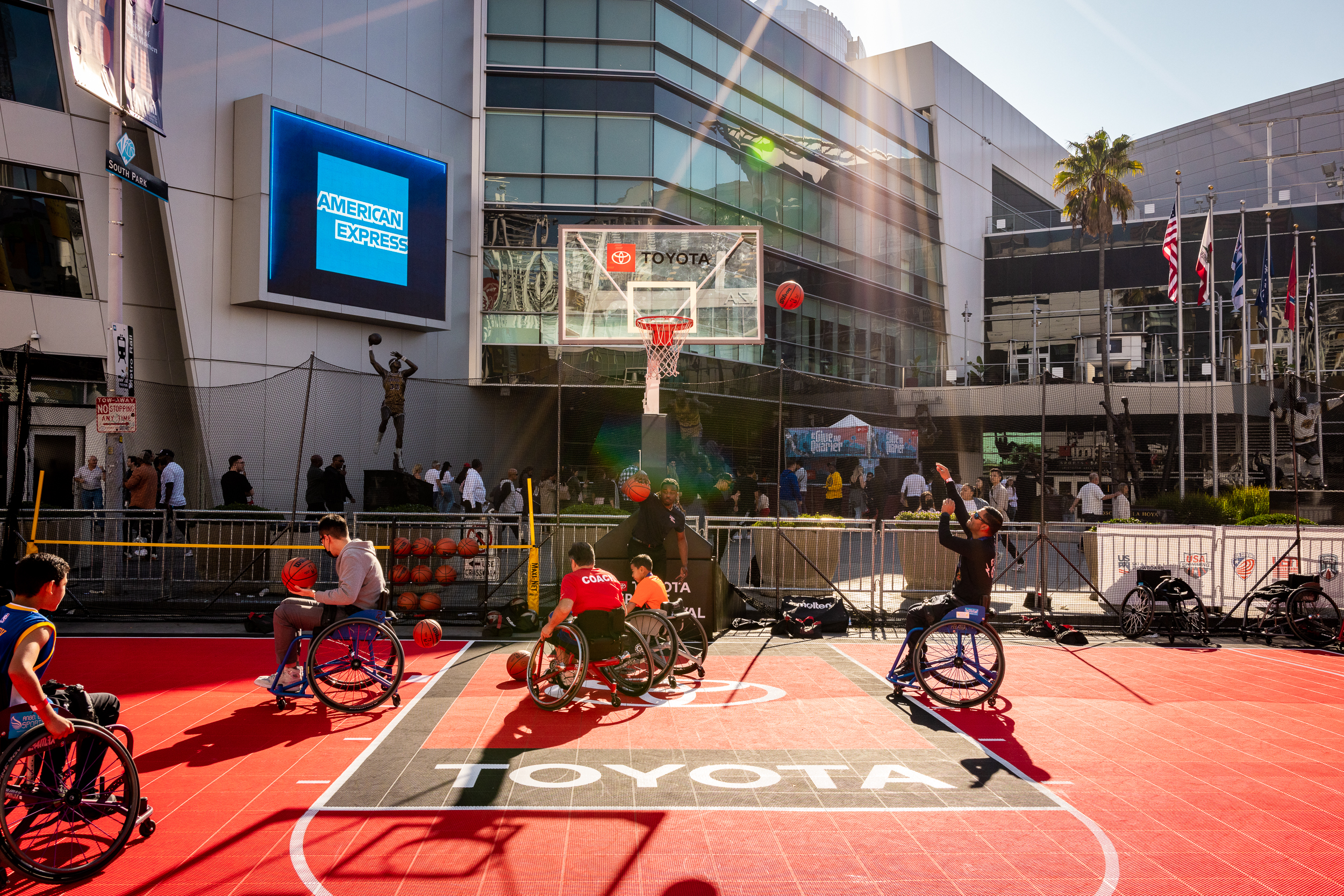 a wheelchair basketball game goes on, on a Toyota branded court